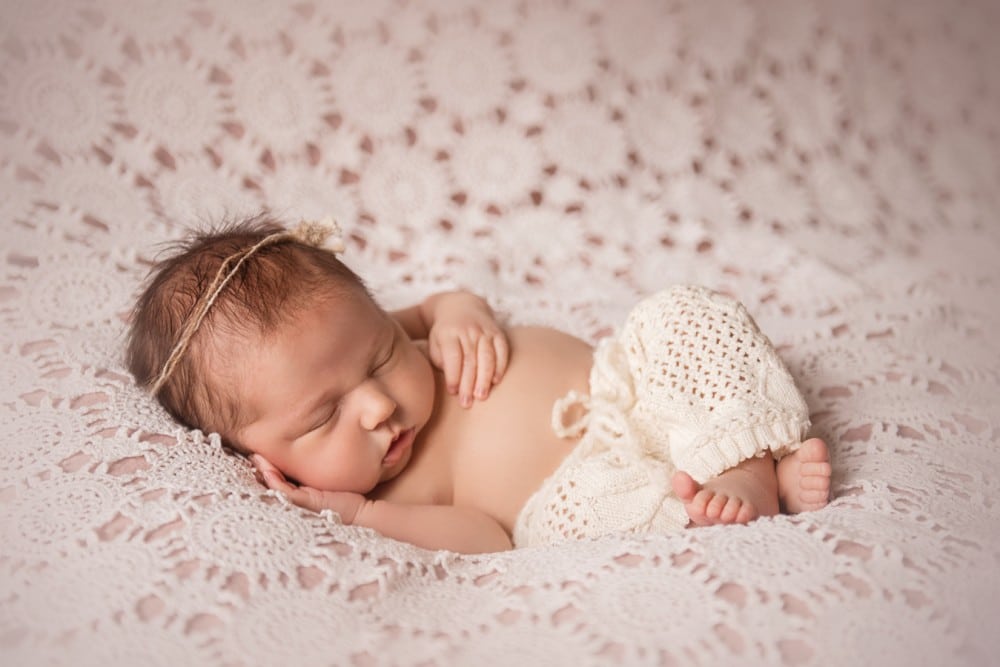newborn baby sleeping with lace pants and lace background - boulder newborn photographer
