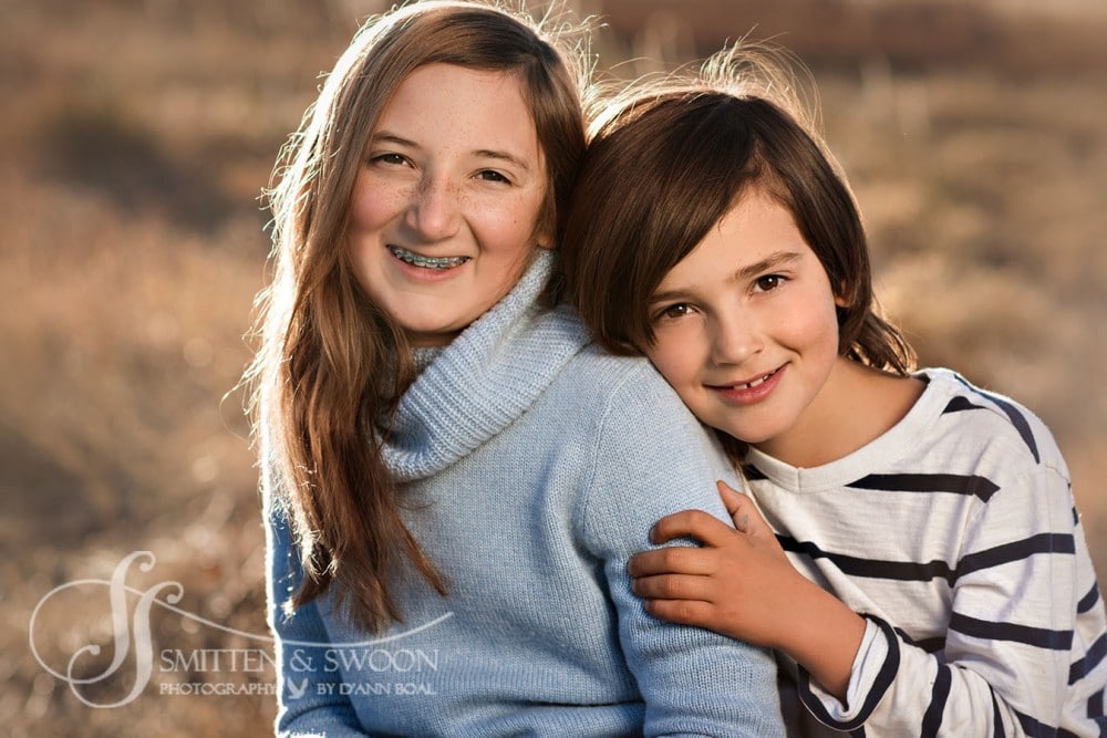 sister and brother leaning into each other smiling at the camera {boulder child photographer}