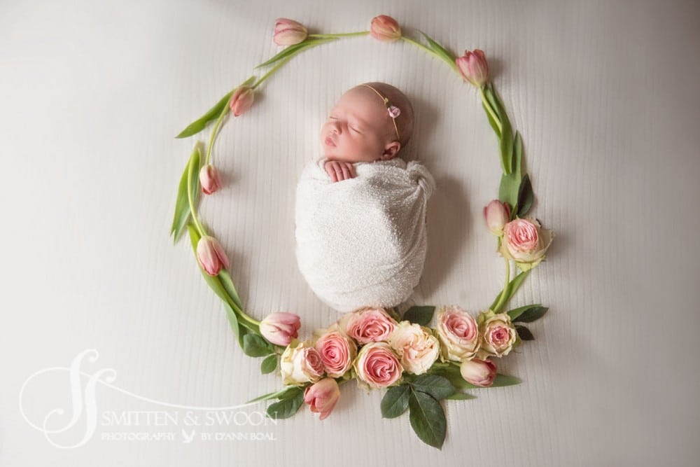 sleeping newborn inside flower wreath