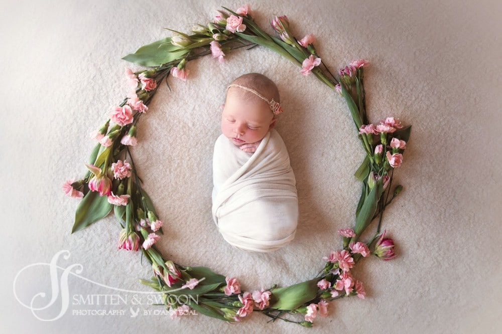 newborn baby girl surrounded with flower garland {Boulder newborn photographer}