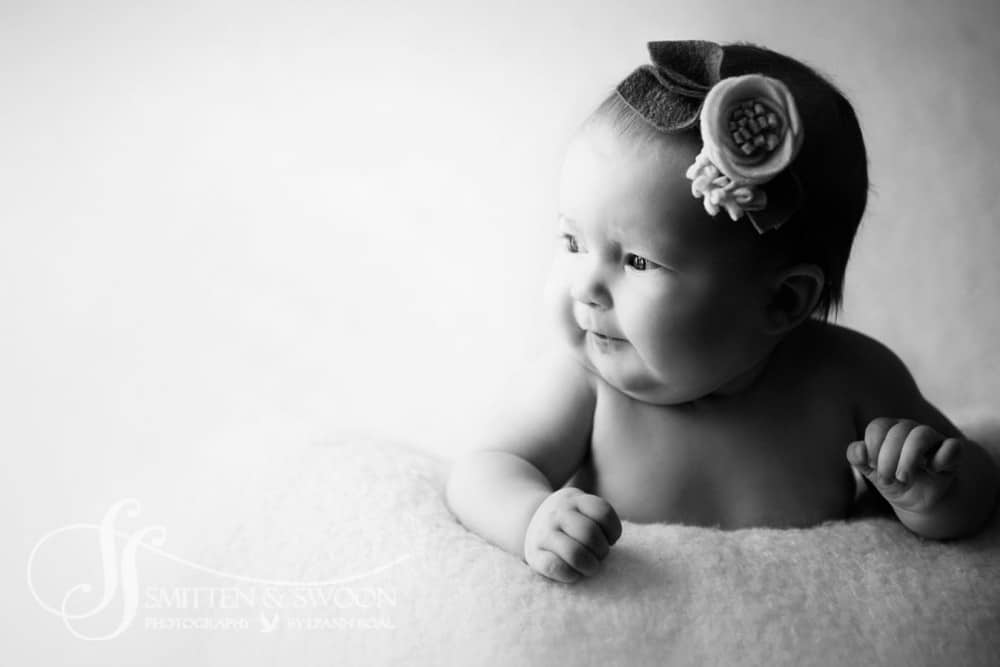 black and white photo of baby girl looking out towards light {boulder baby photographer}