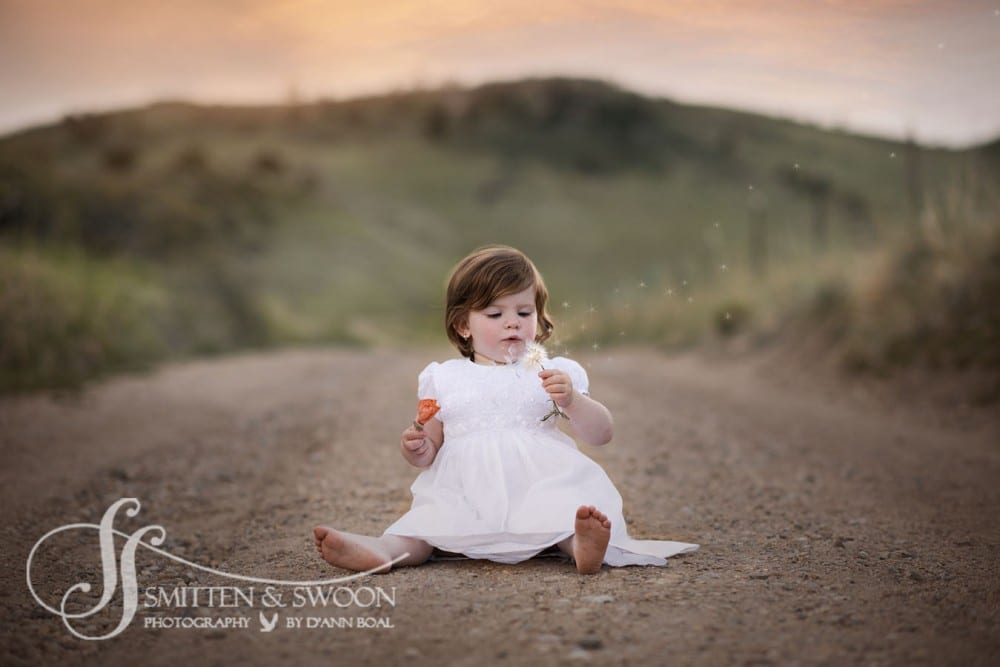 happy girl blowing dandelion {boulder baby photographer}
