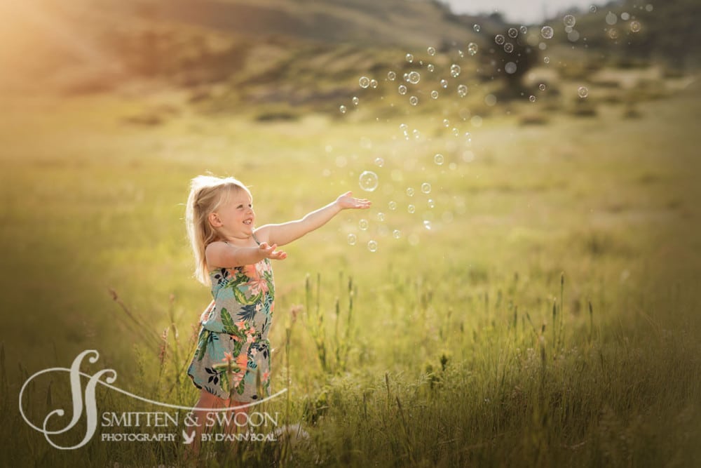 little girl reaching out towards bubbles {boulder child photographer}