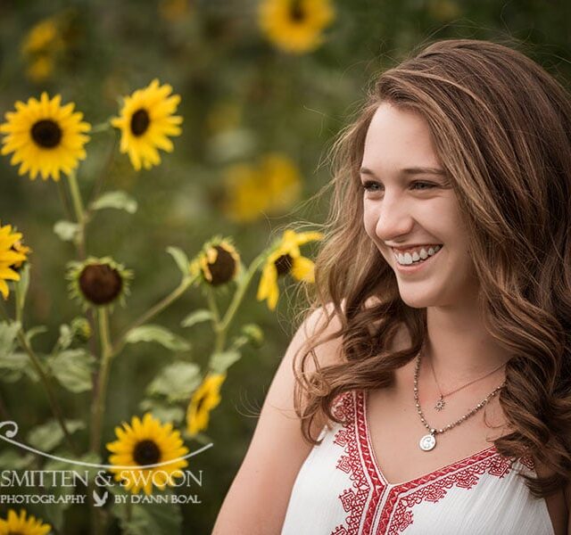 high school senior smiling in field of sunflowers {boulder senior photographer}