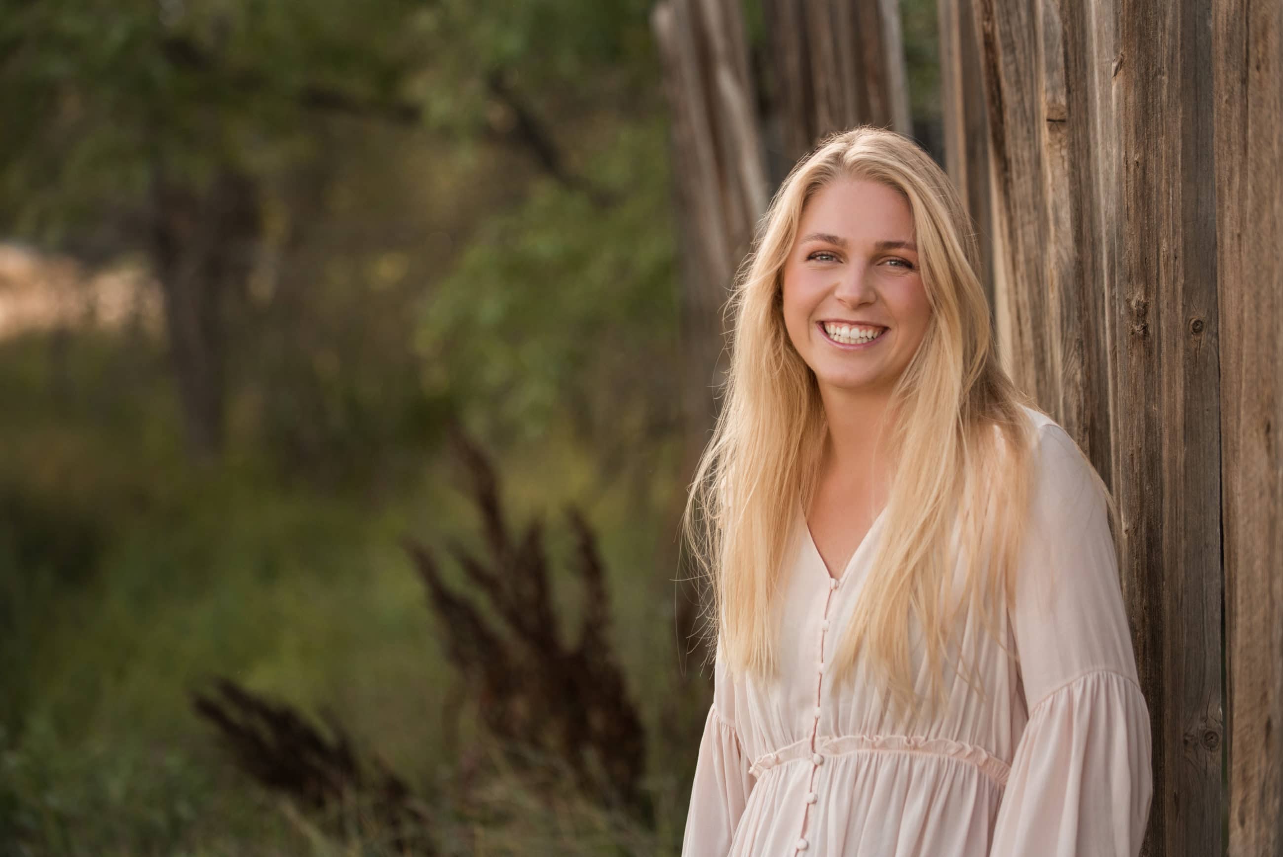senior portrait with rustic fence - boulder senior photographer