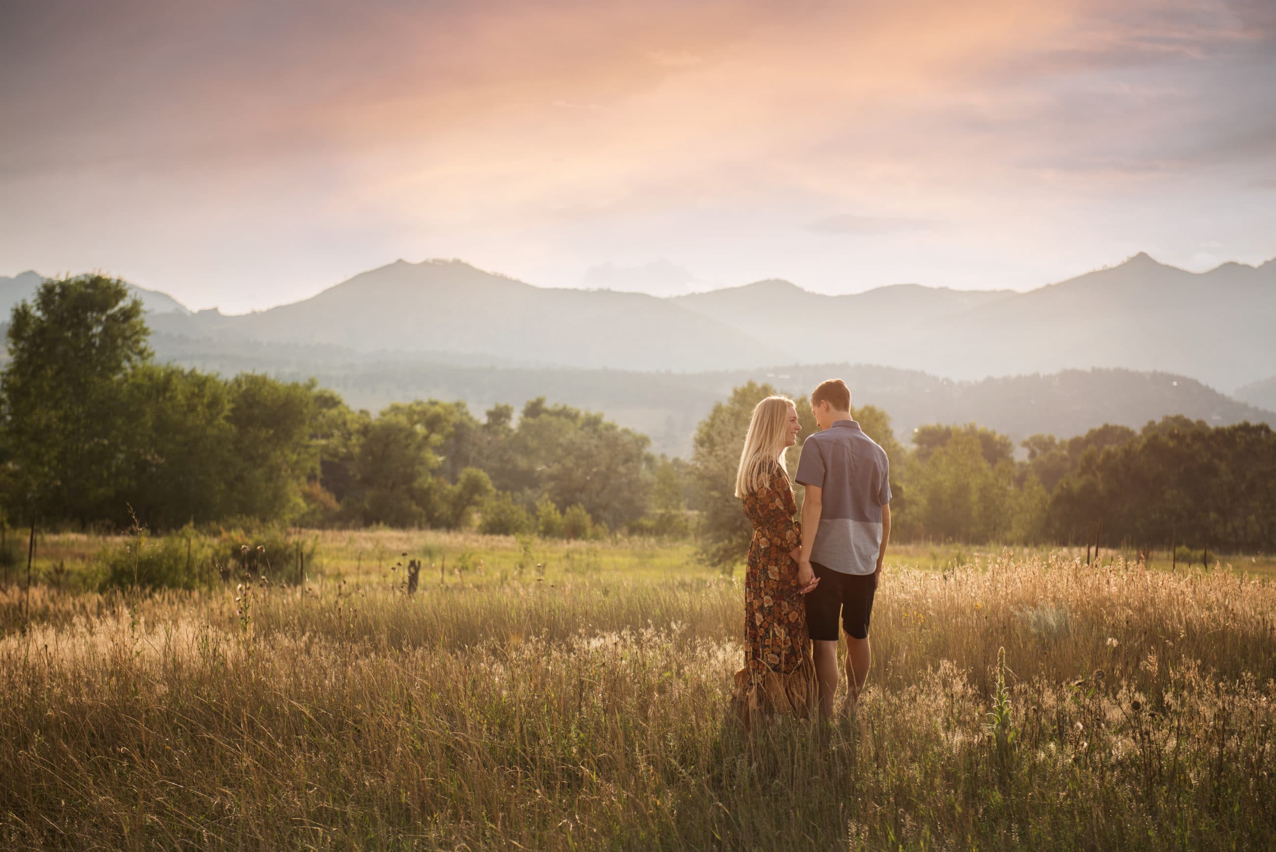 senior girl with her boyfriend in beautiful field at sunset - boulder portrait photographer