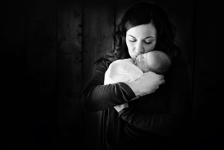 newborn pose with mom black and white mom kissing baby - boulder newborn photographer