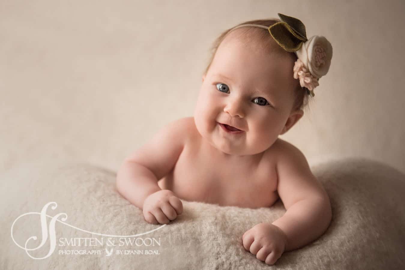 boulder photographer baby girl smiling at camera with felt headband