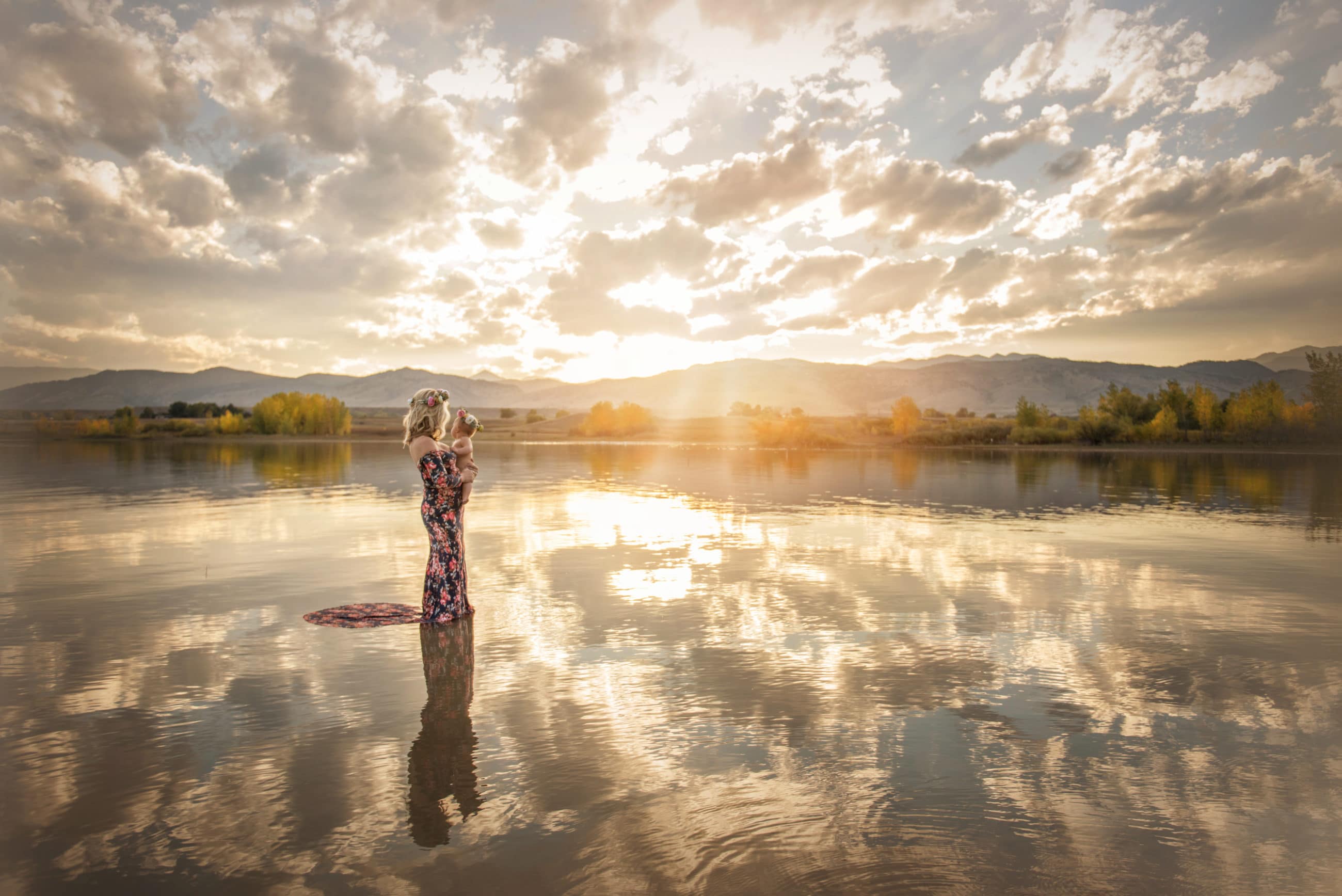 mom and daughter in lake at sunset with flower crowns and reflections - boulder baby and child photographer