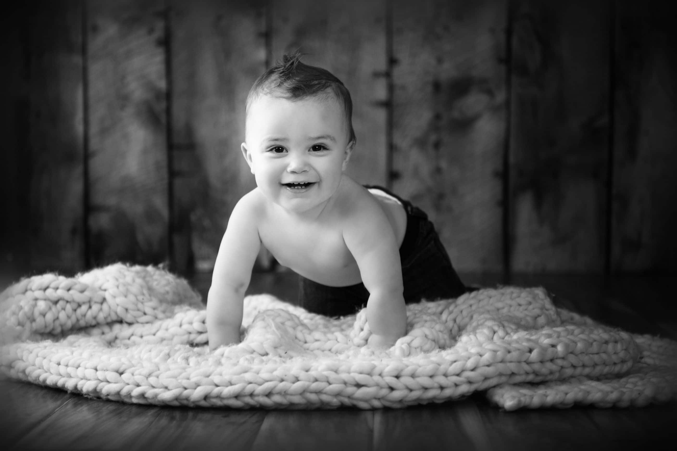 one year old baby boy crawling and smiling black and white - boulder newborn photographer