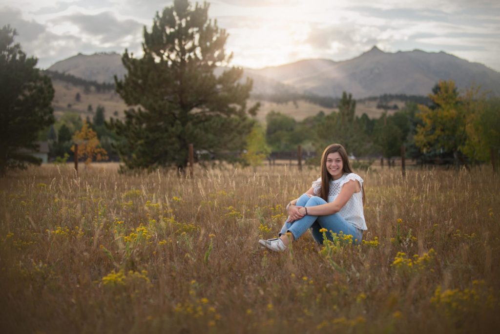 complimentary colors - senior girl sitting in field Boulder photographer