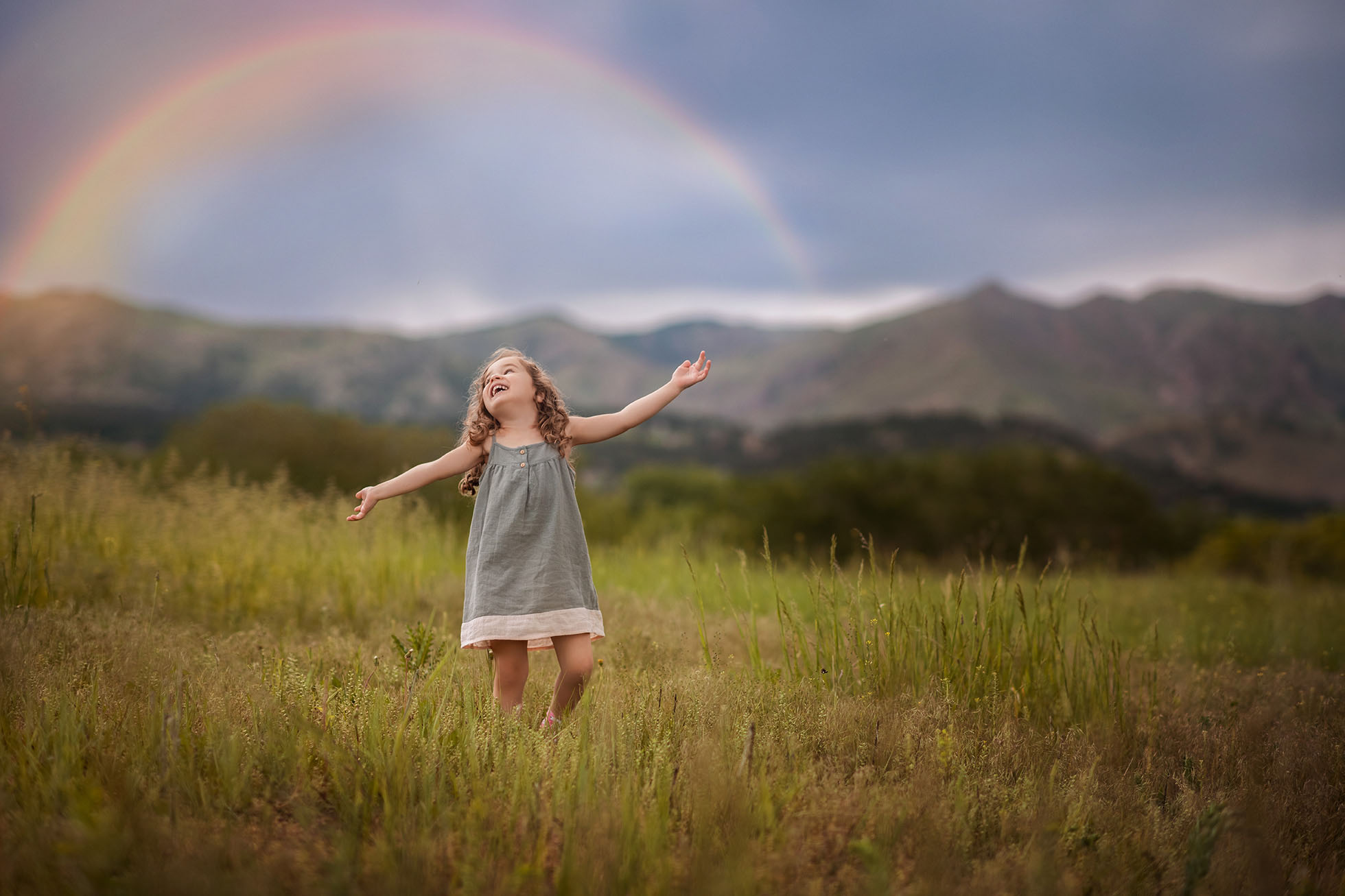 little girl dancing under rainbow Boulder newborn child & family photographer | the experience