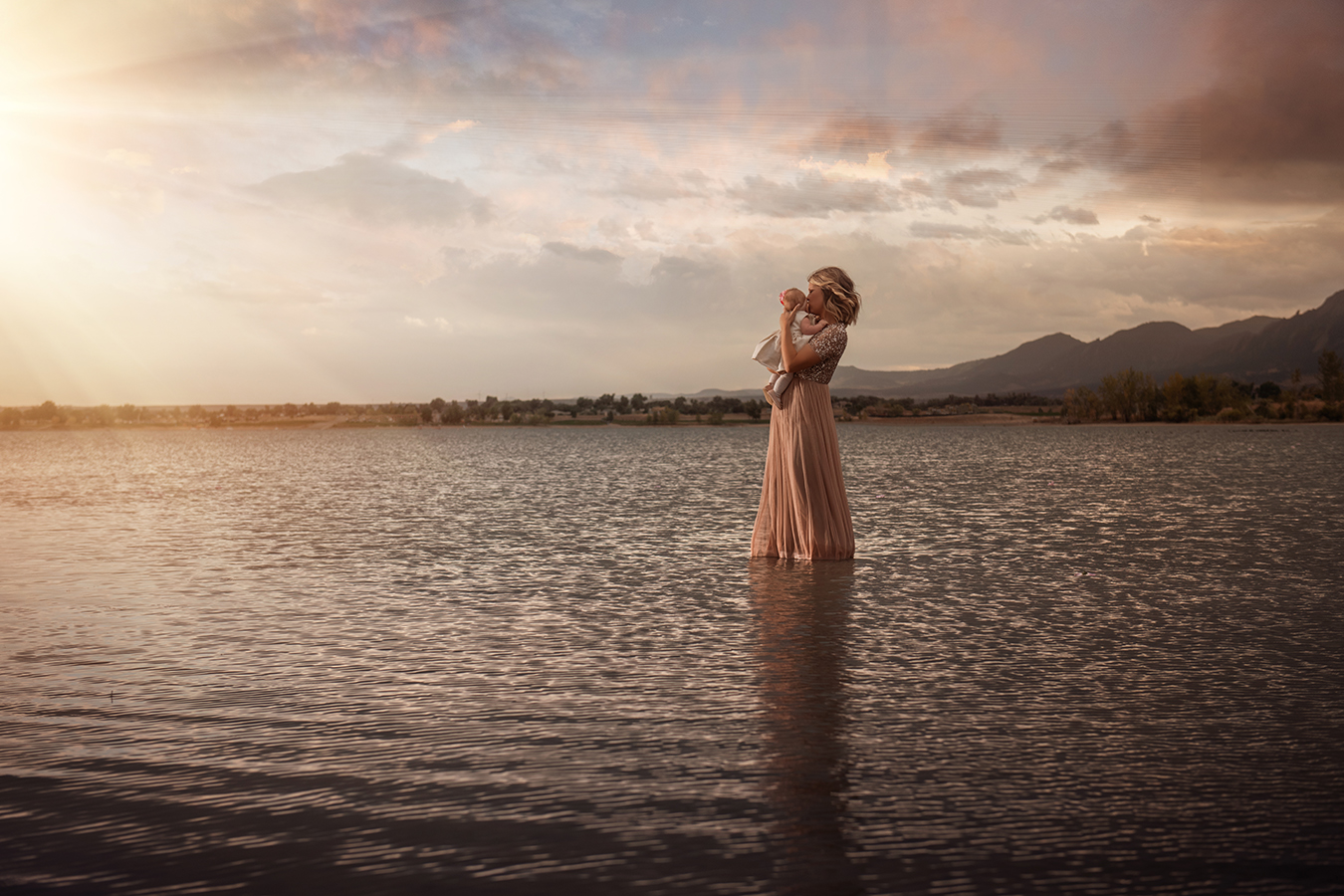 mother and baby in sparking gown in a lake at sunset - boulder photographer