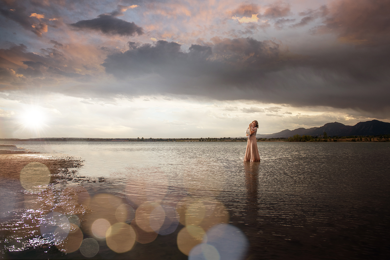 mother and baby girl in a lake at sunset with bokeh - boulder photographer