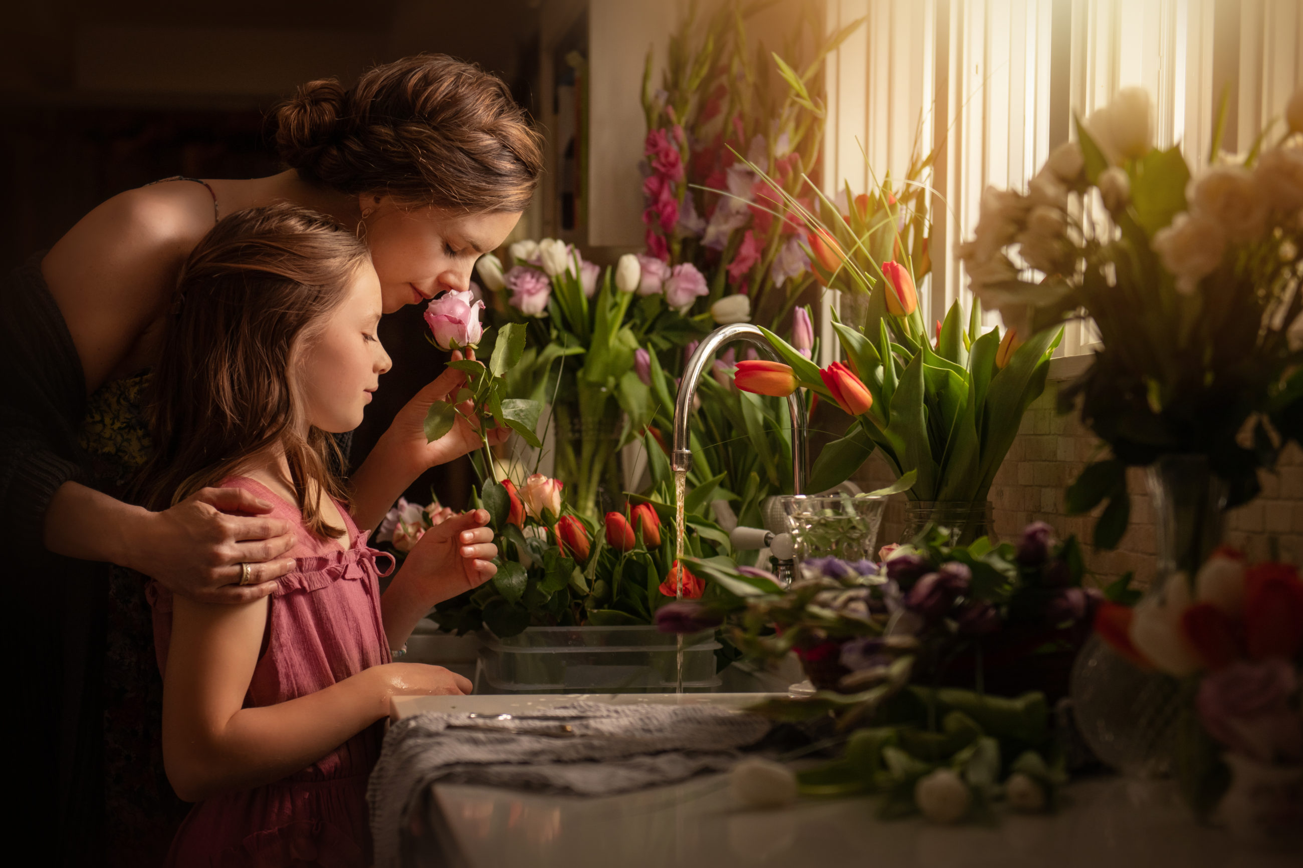 boulder Colorado photographer - mom and daughter smelling a hundred flowers in kitchen
