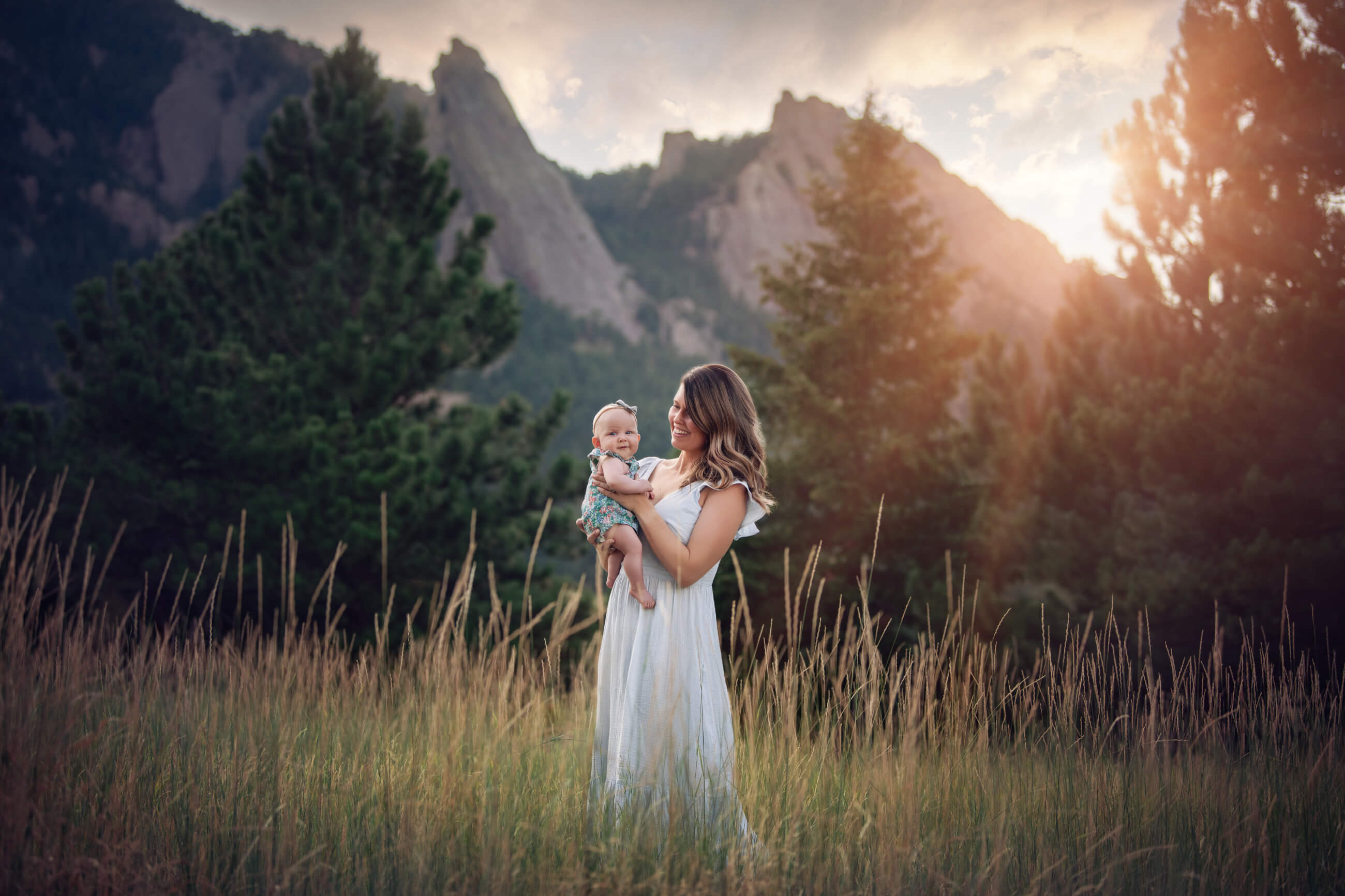 mom holding baby at sunset boulder family photographer 
